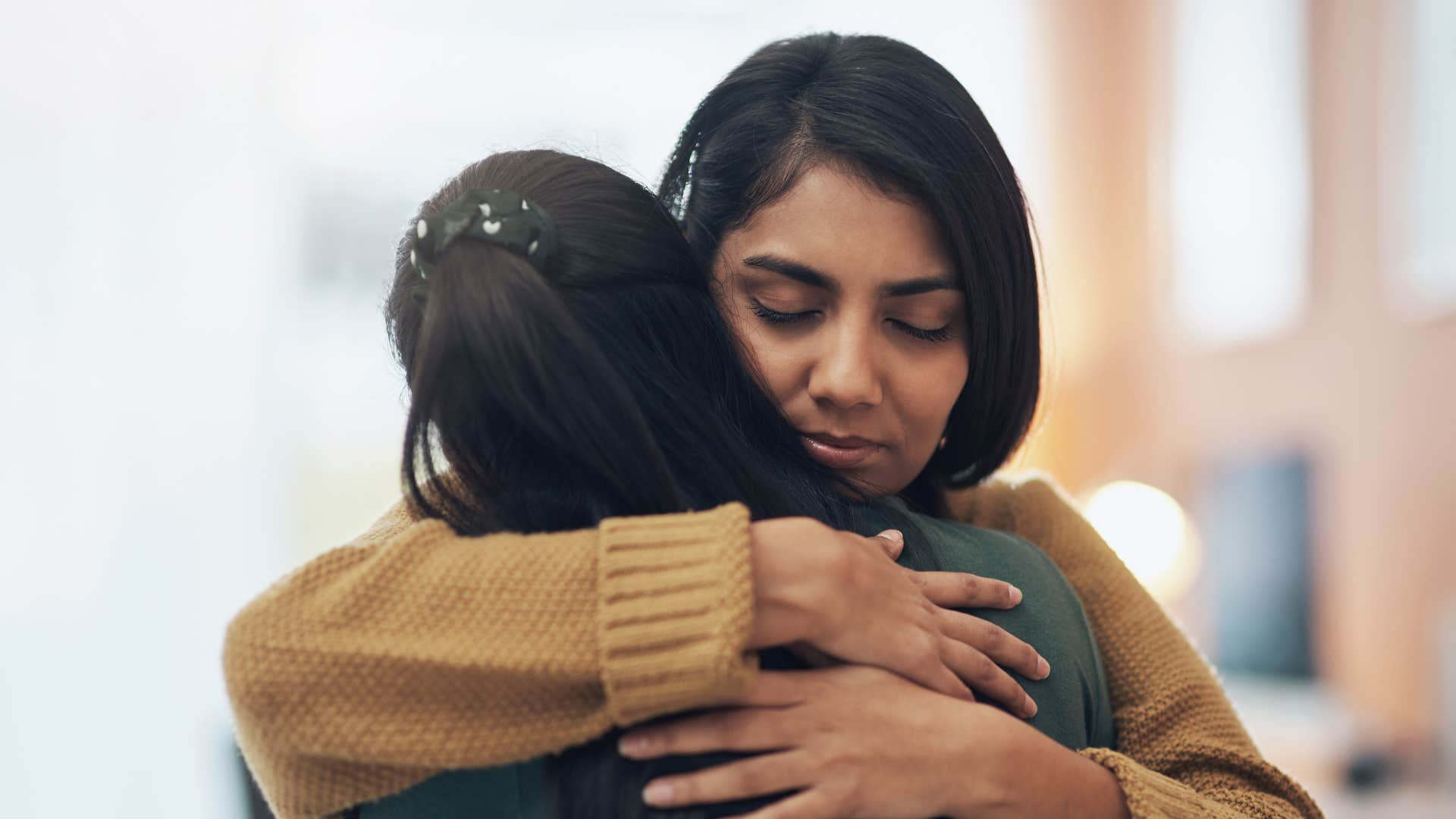friends hugging as friend demands constant validation