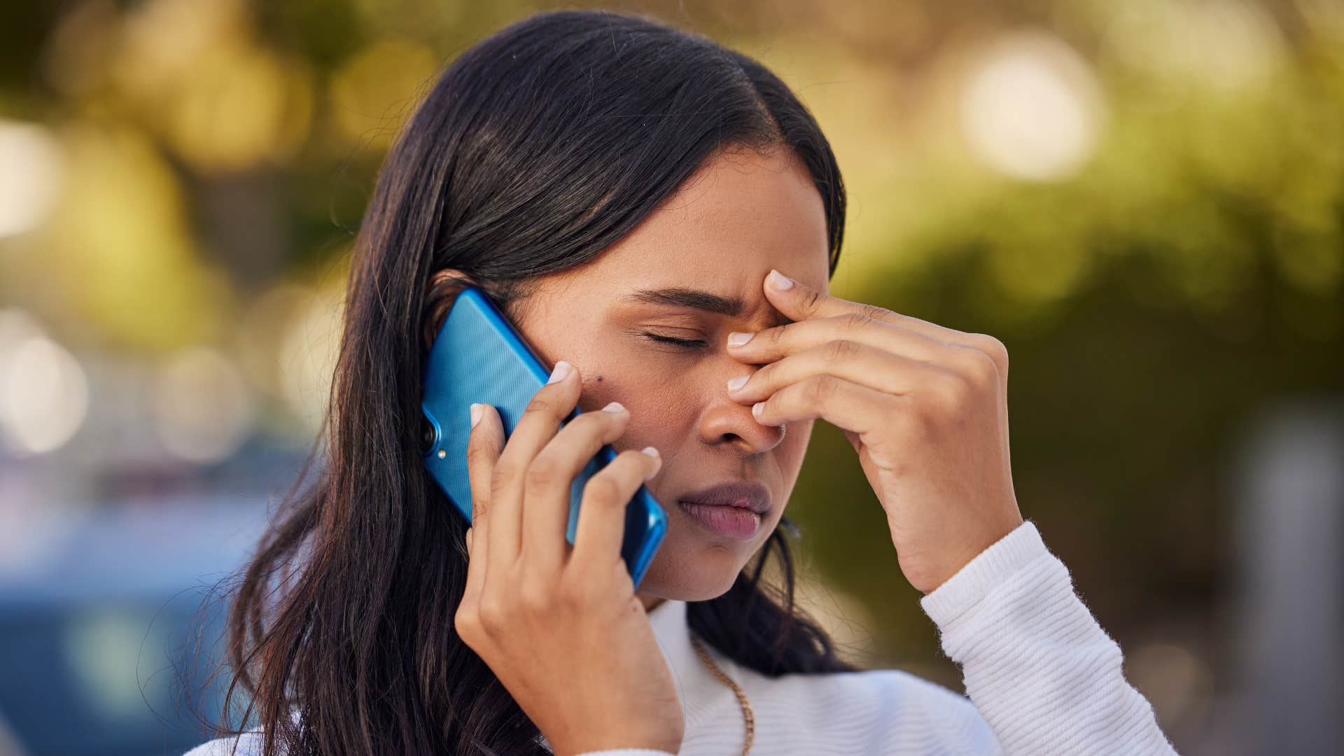 woman putting hand in head as she deals with friend who demands emotional labor from her