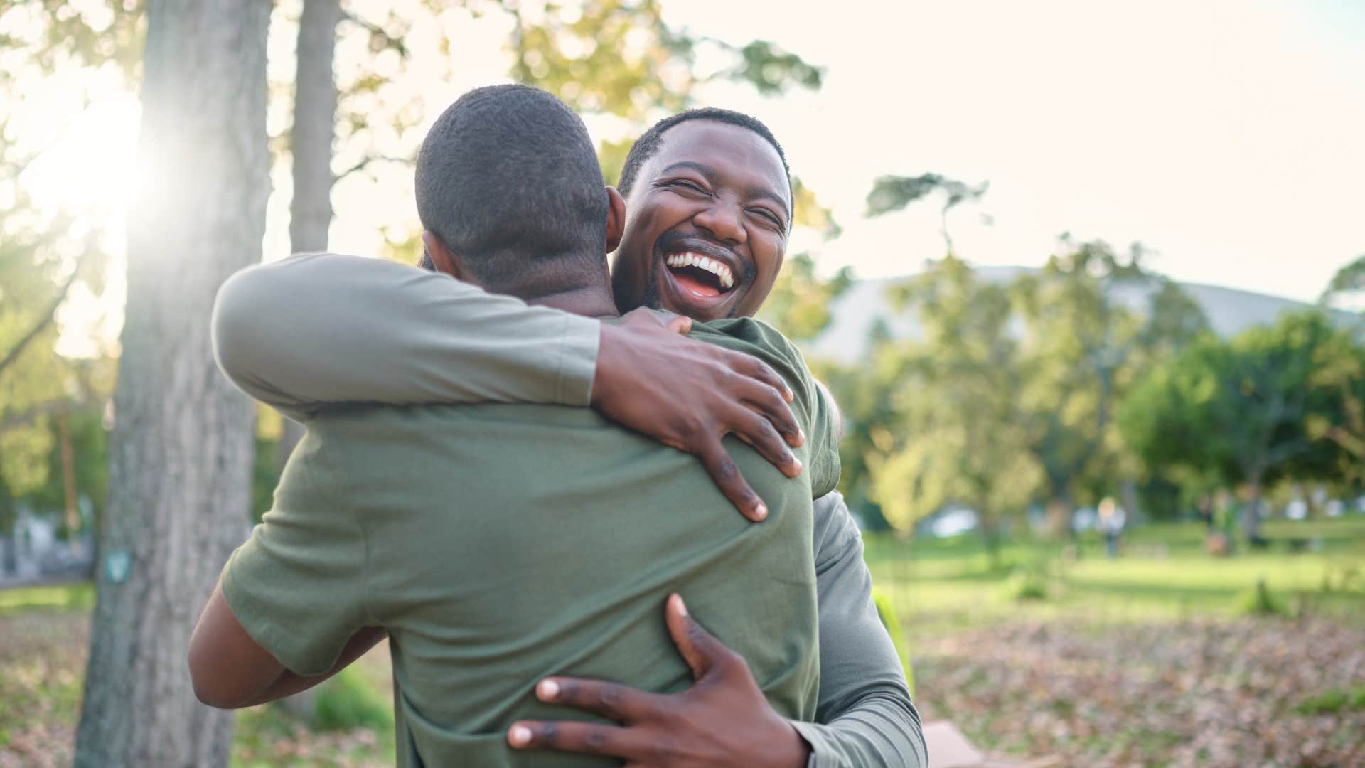 two guy friends hugging as friend is always happy for him 