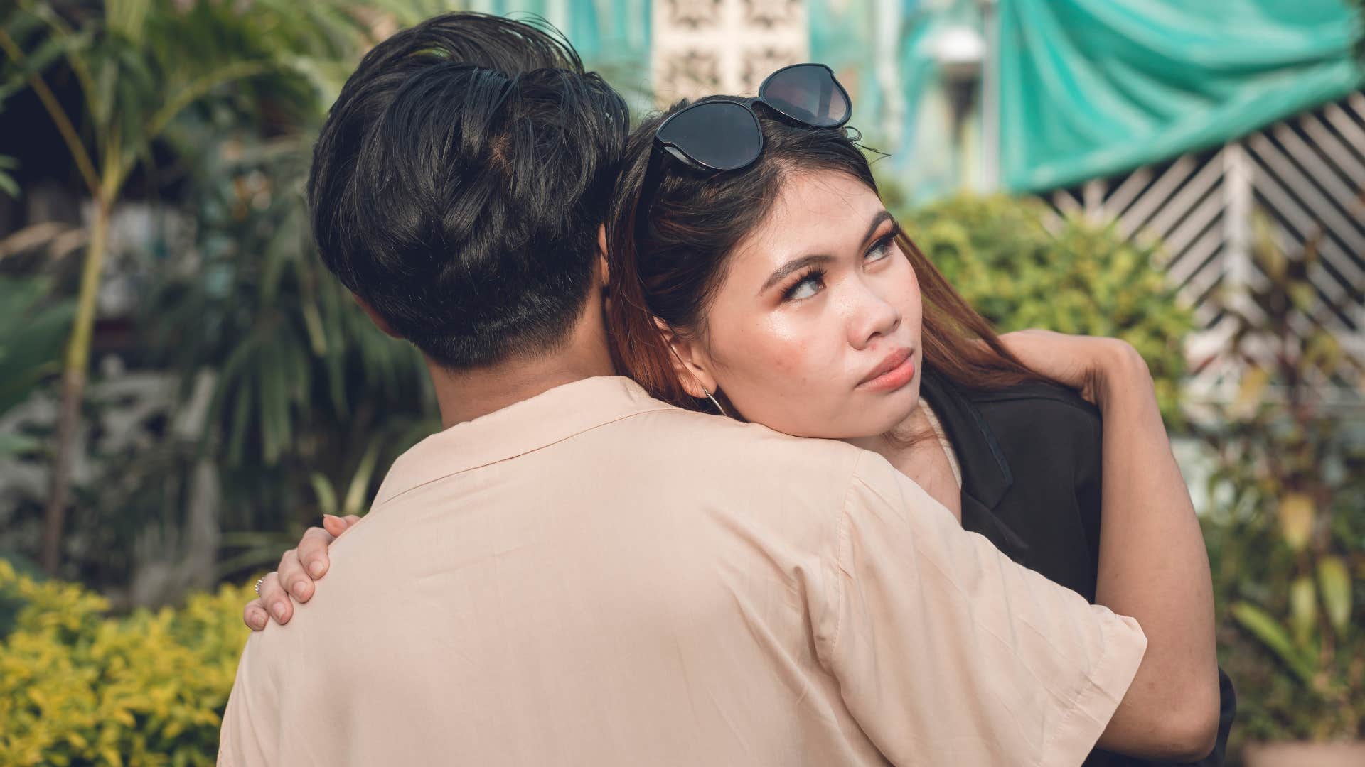 things that were once considered polite but now young generations think are rude forcing a hug woman being forced to hug friend