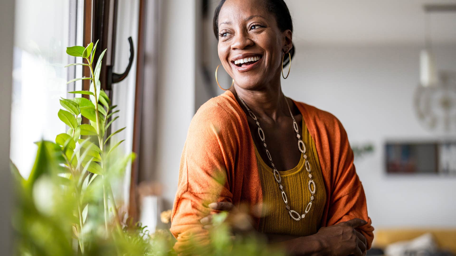 intelligent woman smiling standing in living room