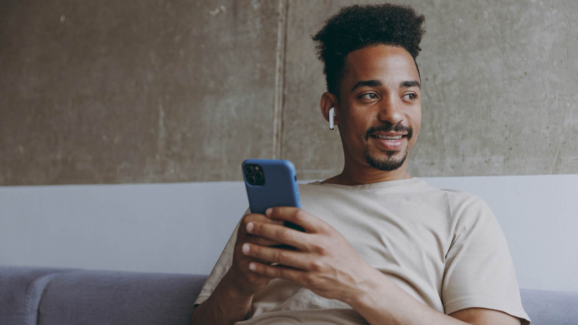 man listening to music while sitting on couch