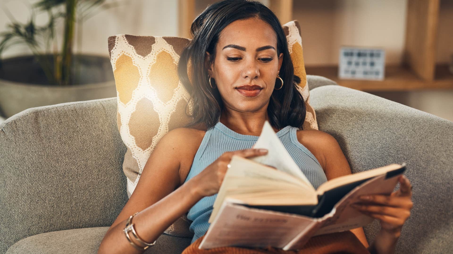 woman reading her favorite book on couch