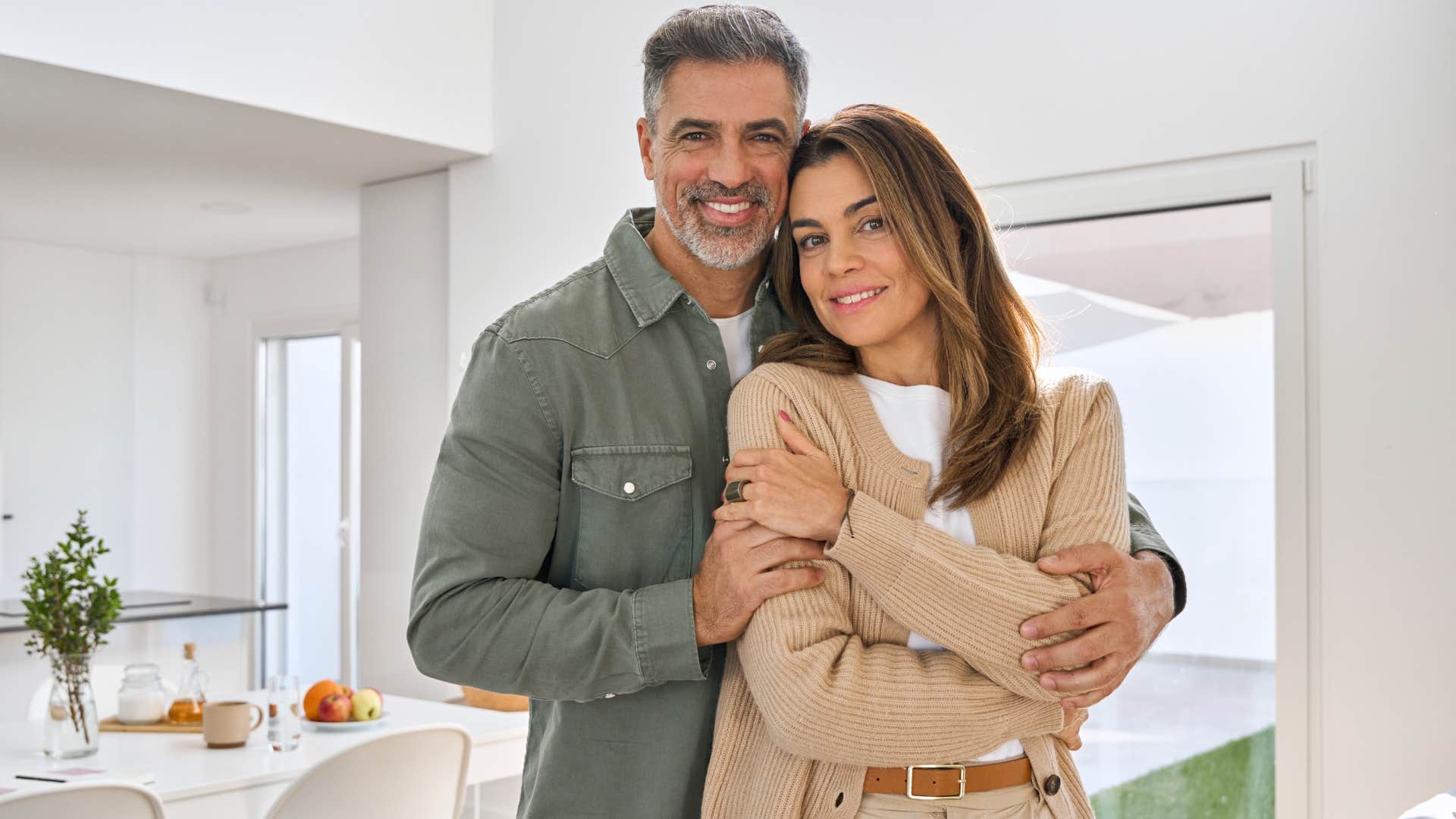 rich couple wearing plain clothing at home.