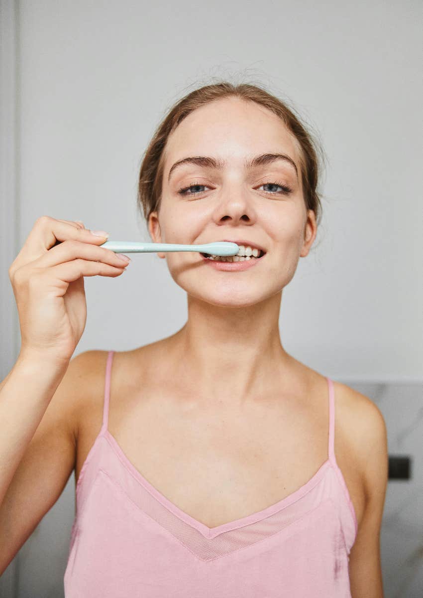 woman brushing her teeth