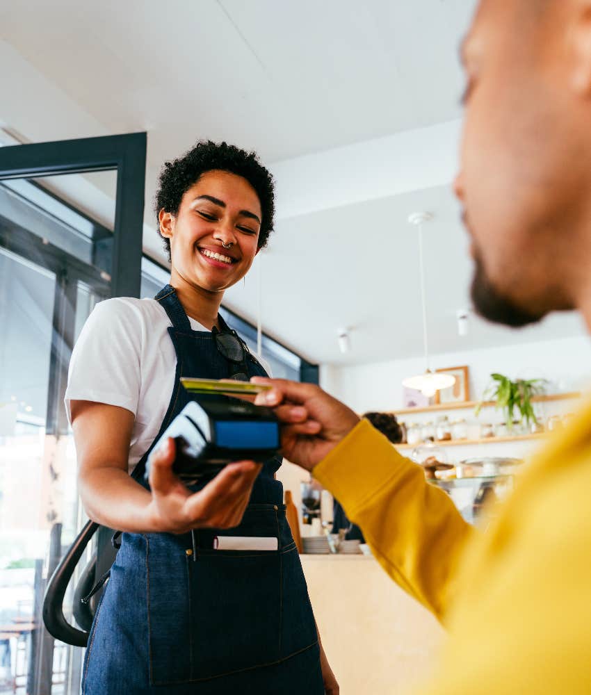 customer paying and tipping server