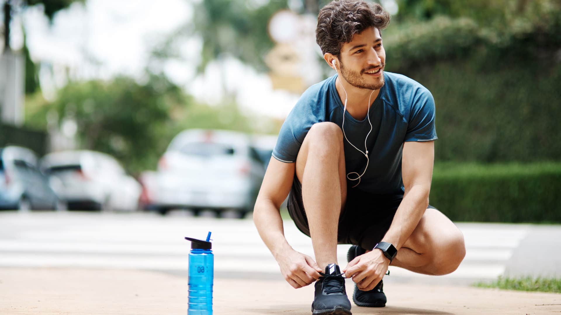 man tying his shoe during jog outside