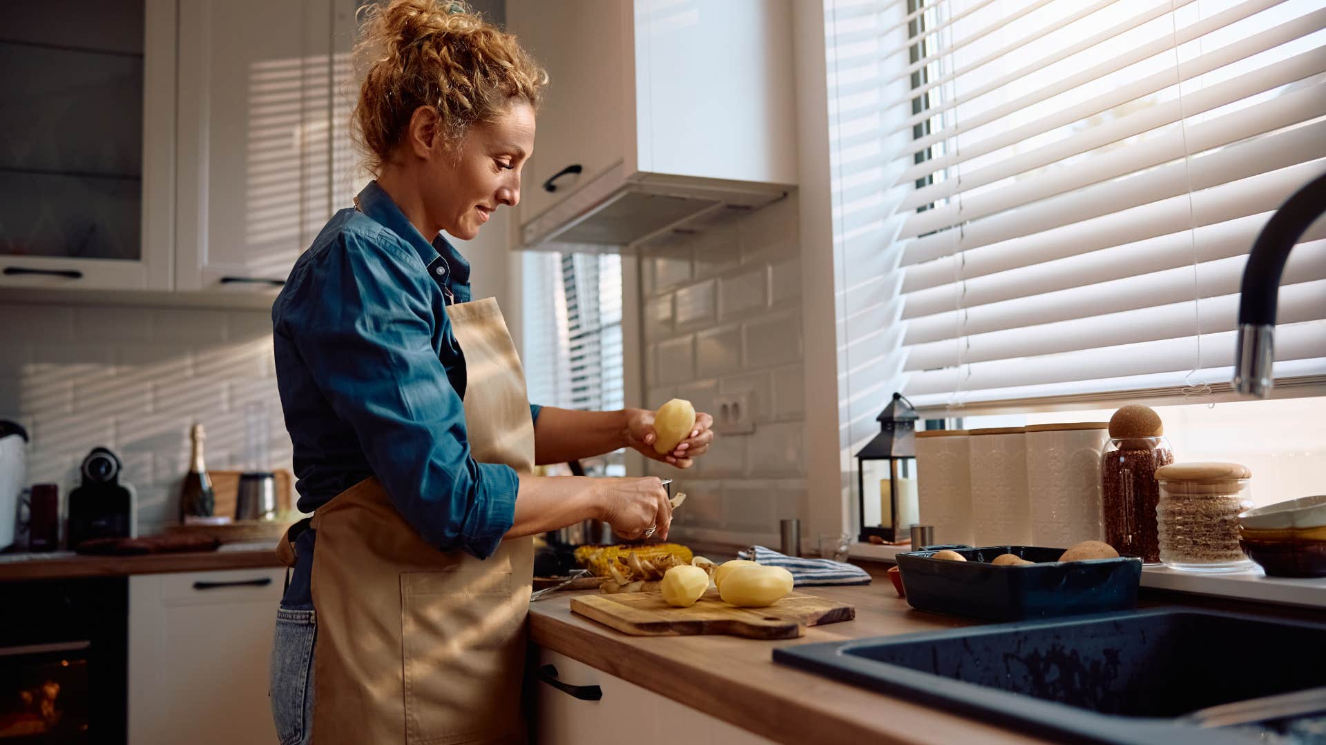 woman cooking meal at home in kitchen