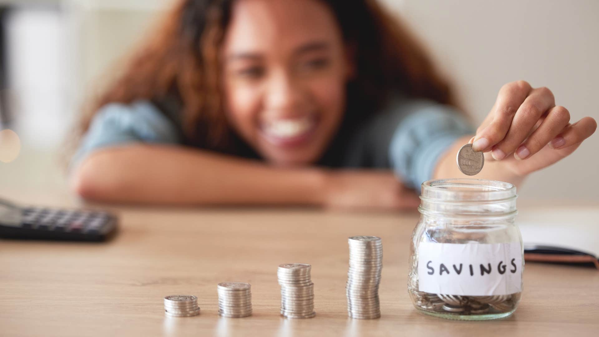 woman putting change in jar