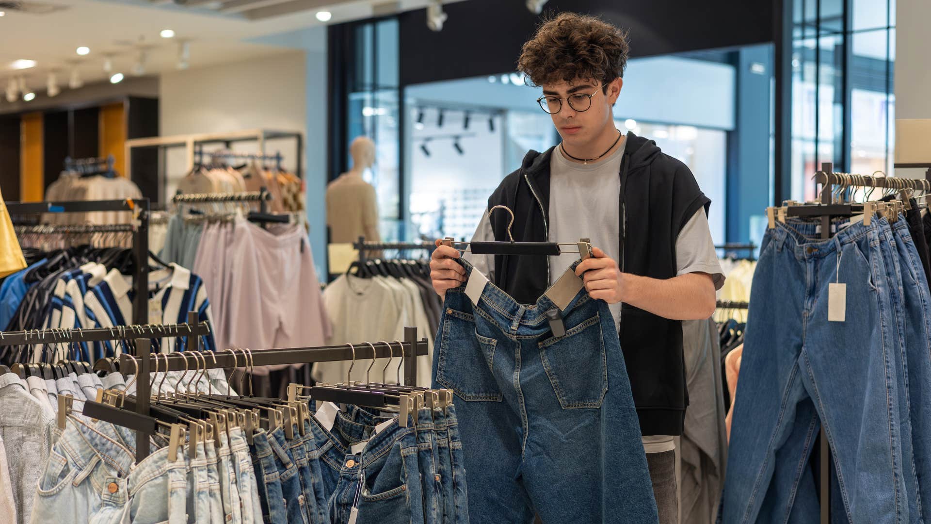 young man shopping clearance on jeans at store