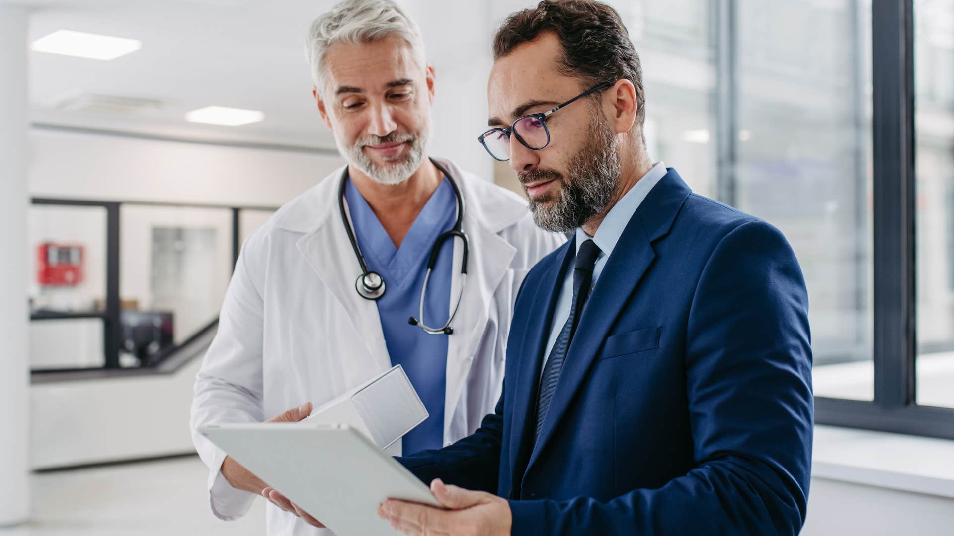 Man with access to private healthcare talking to a doctor.
