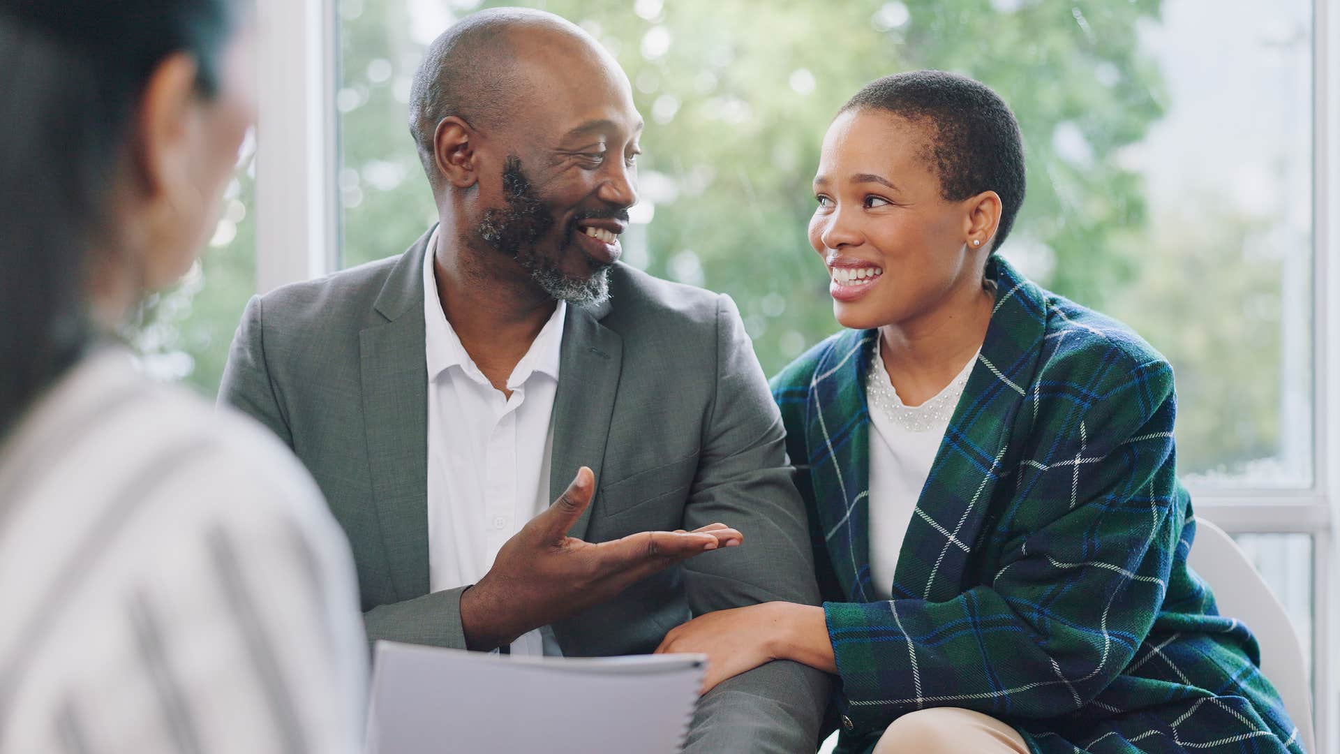 Upper-class couple talking to a financial advisor.
