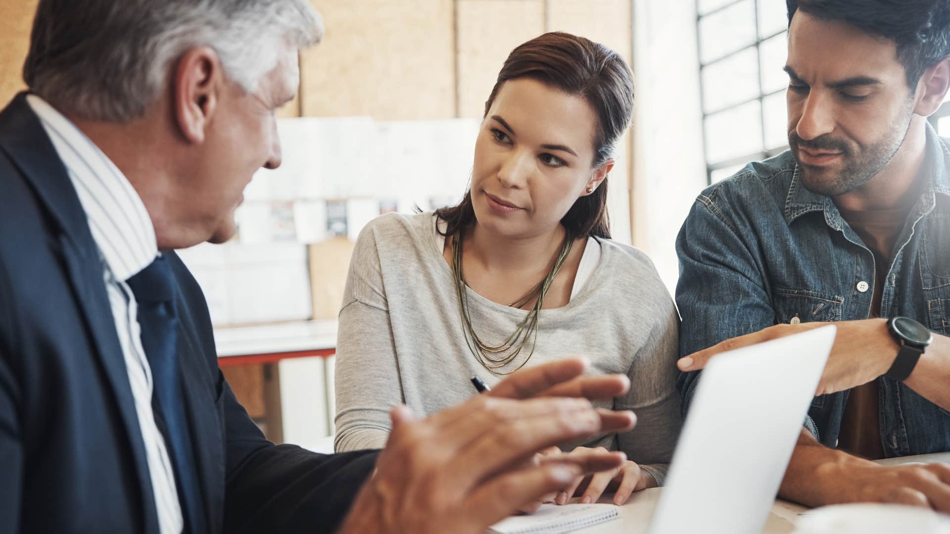 Couple talking about a trust fund or a portfolio with an advisor.