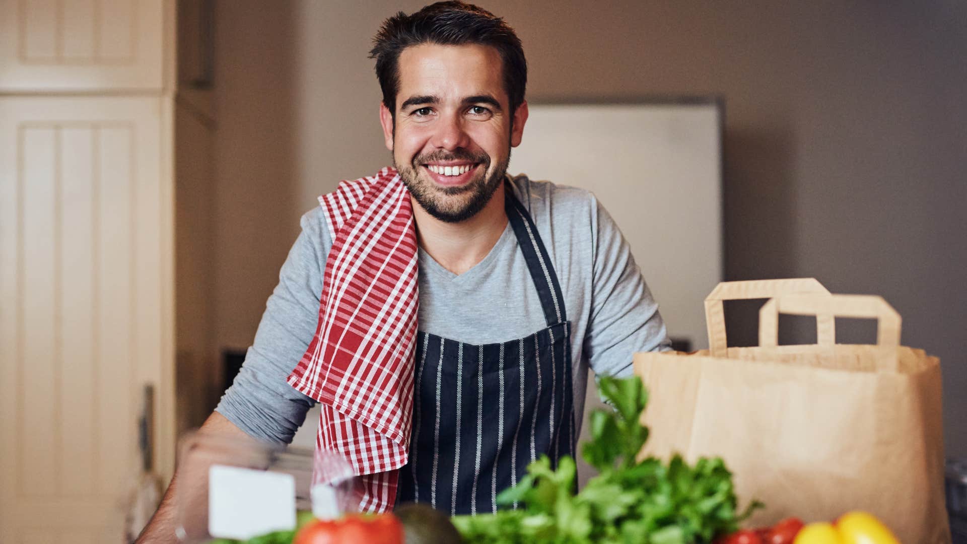 Man smiling in his walk-in fridge at home.
