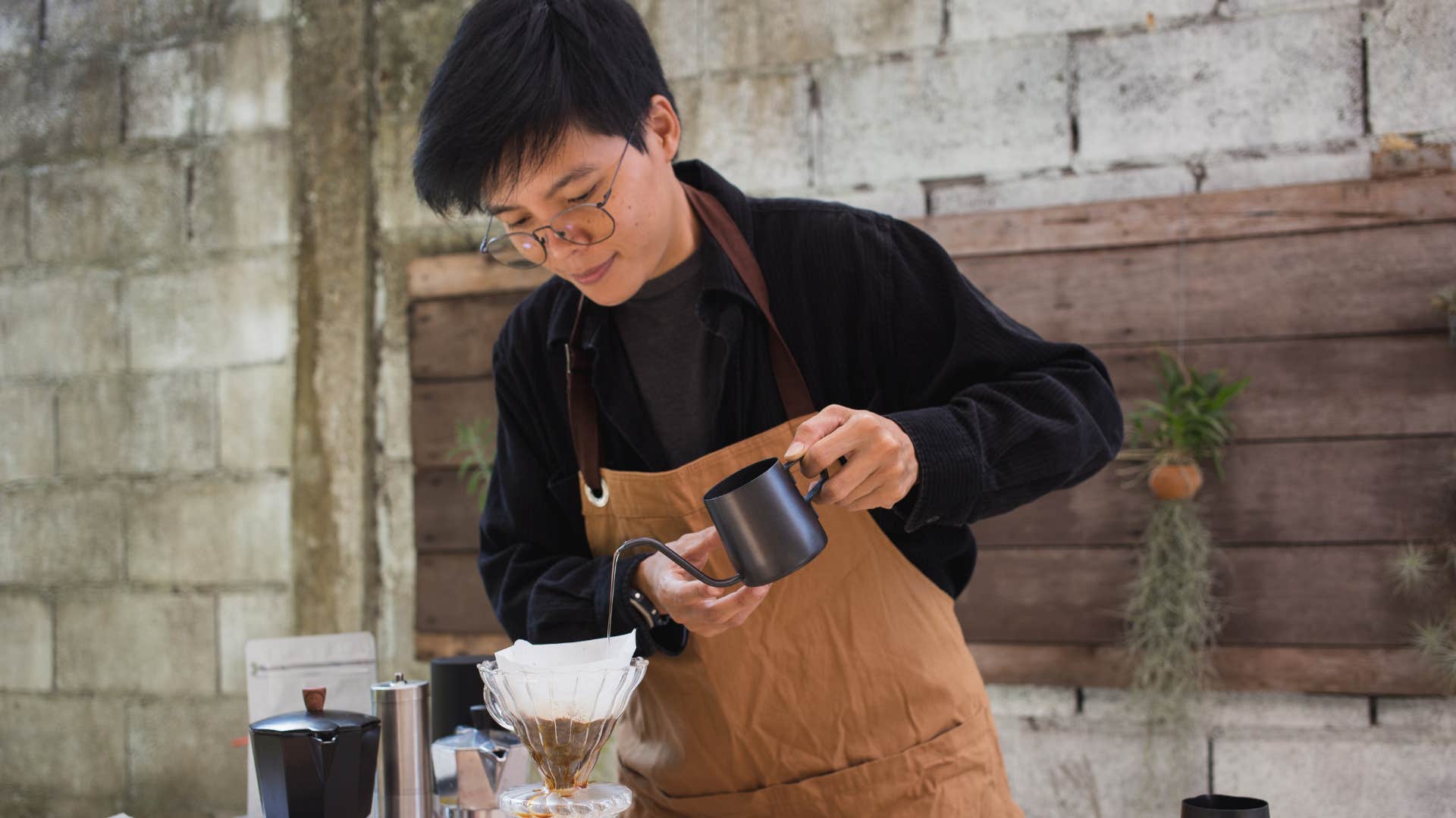 man brewing coffee with a complicated set up