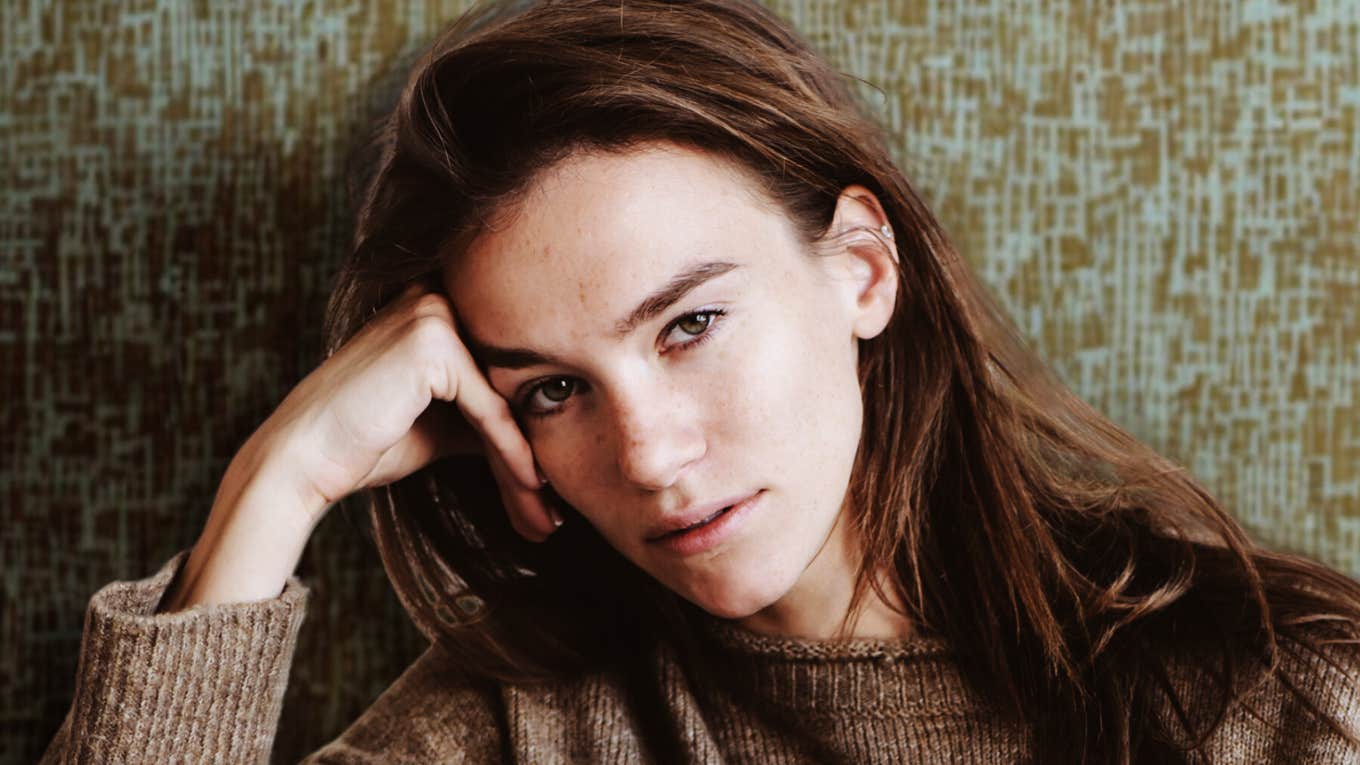 Thoughtful young woman indoors, embodying the deep emotion and soul sensitivity of a highly sensitive person.