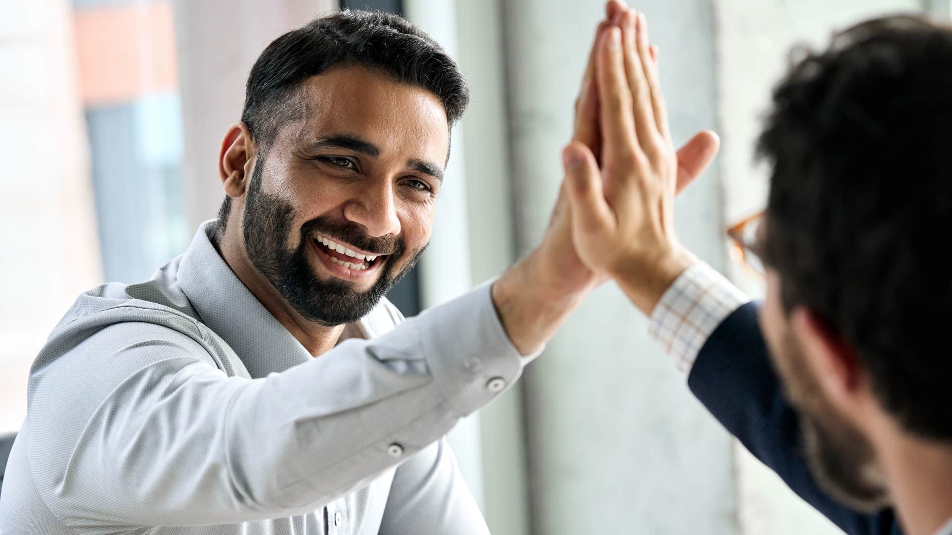 two trailblazers giving each other a high five at work