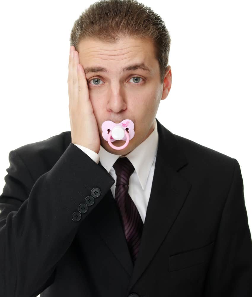 Adult man using pacifier to manage stress