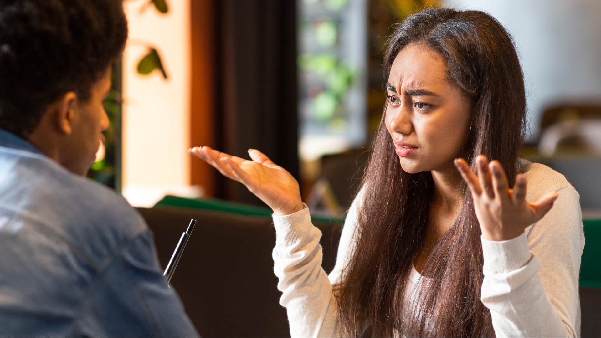 woman trying not to pass the blame in tense conversation
