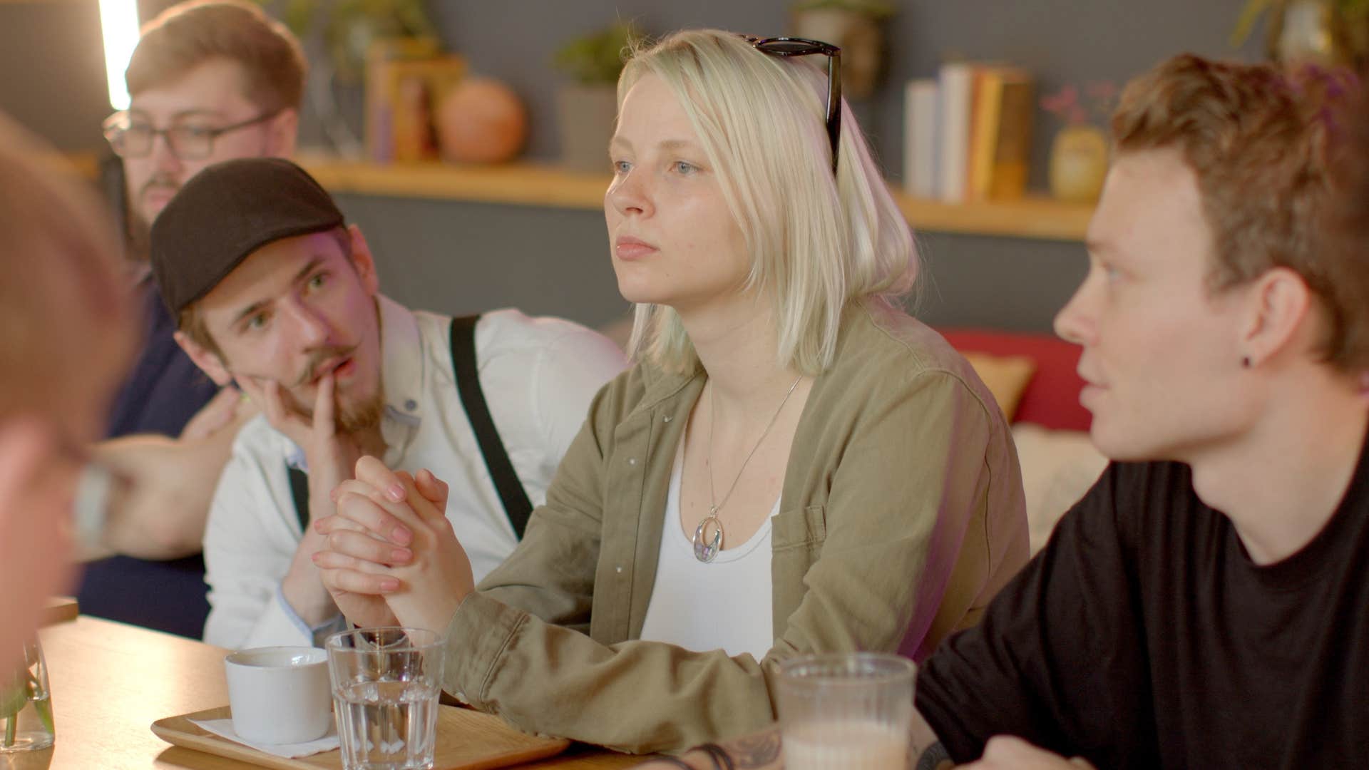group of friends talking trying to leave other people out
