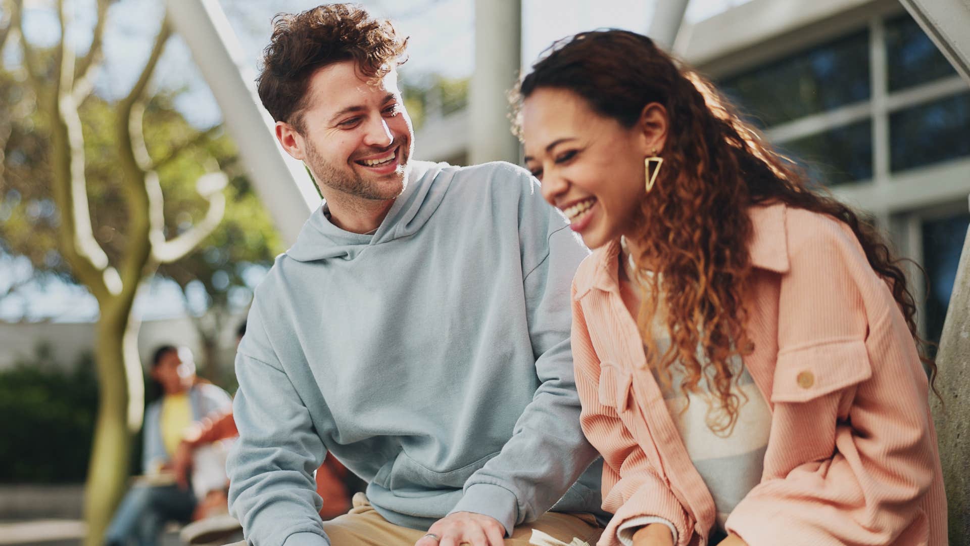 Man who leads with warmth talking to a friend.