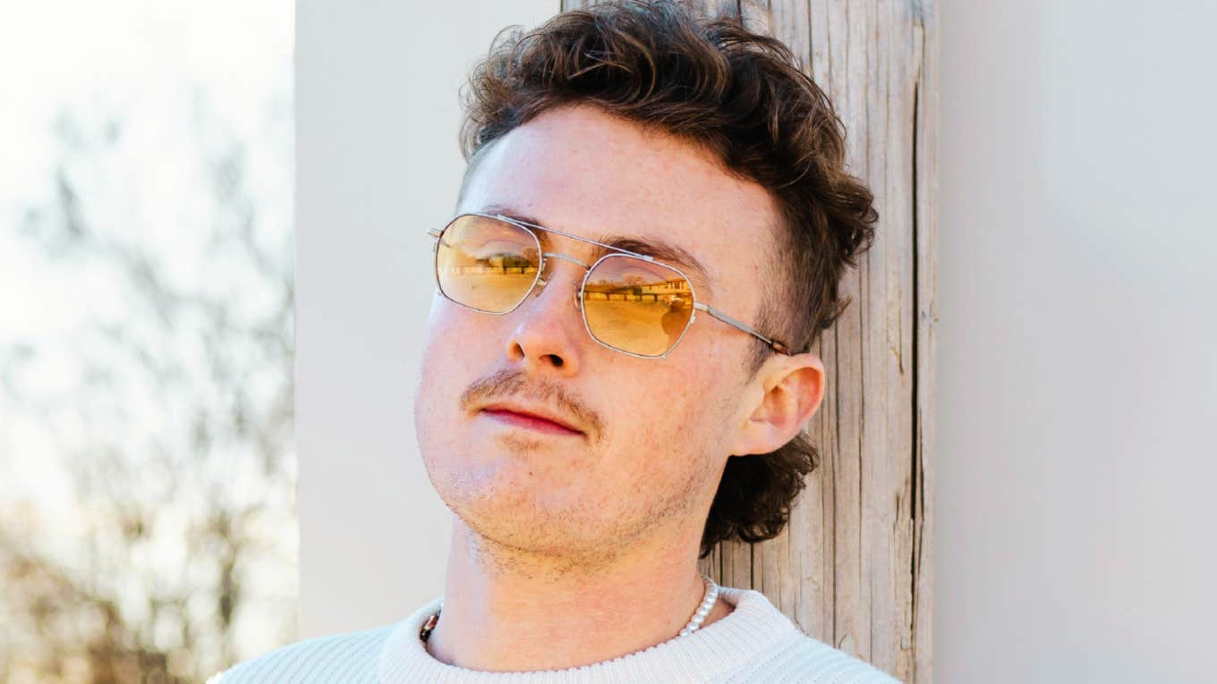 Types Of Guys Who Stay Single Because They Never Healed Their Childhood Wounds Confident man wearing sunglasses, representing types of guys who stay single due to unhealed childhood wounds