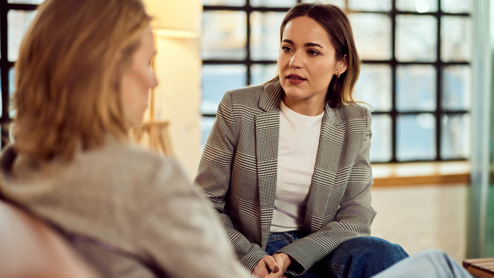 woman talking to an overconfident faker at work