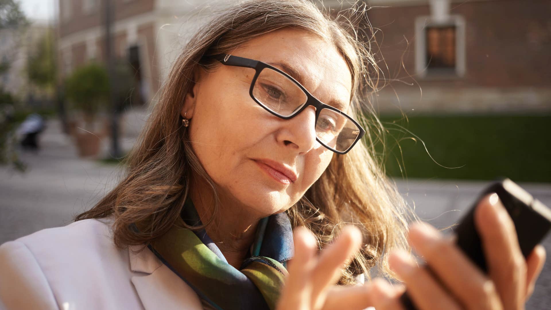 gen x woman scrolling on her phone