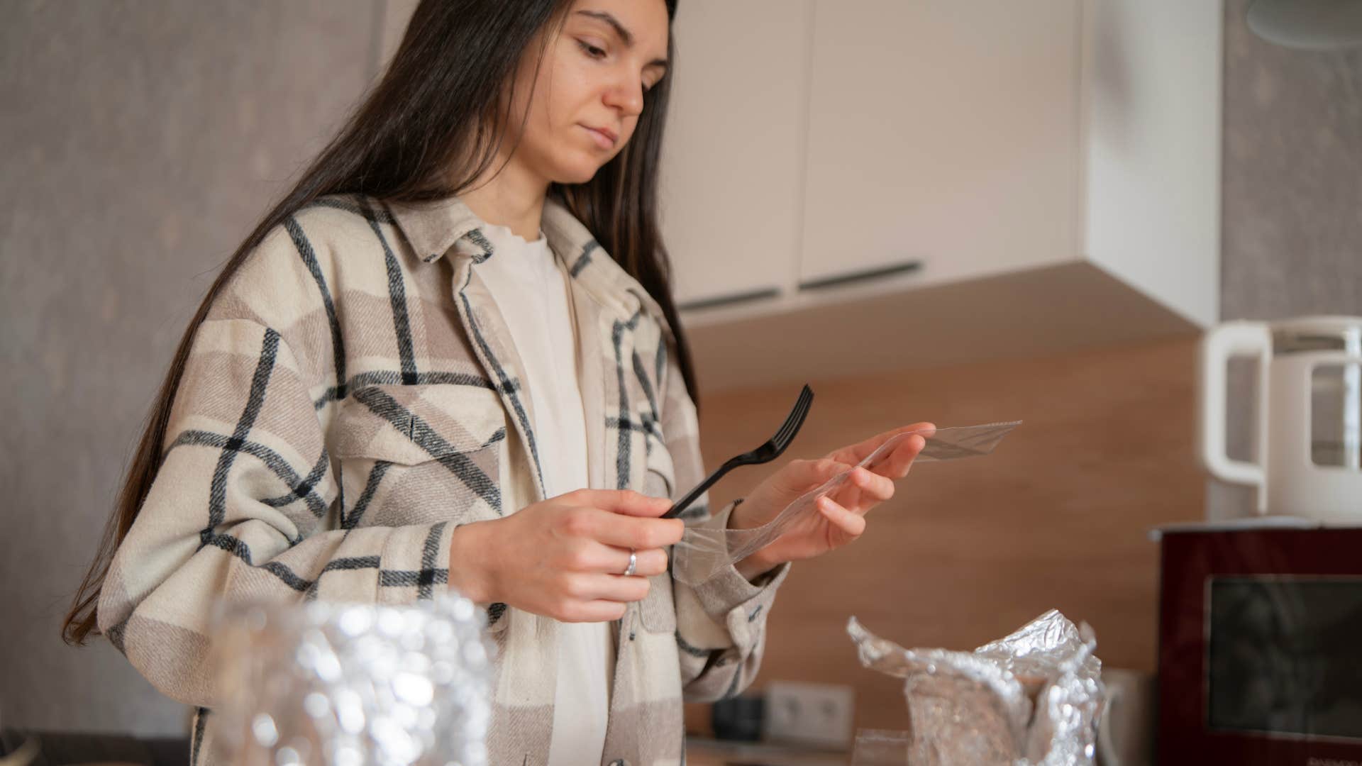 unnecessary free things people refuse to throw away because they might be useful someday plastic takeout utensils woman saving plastic takeout utensils