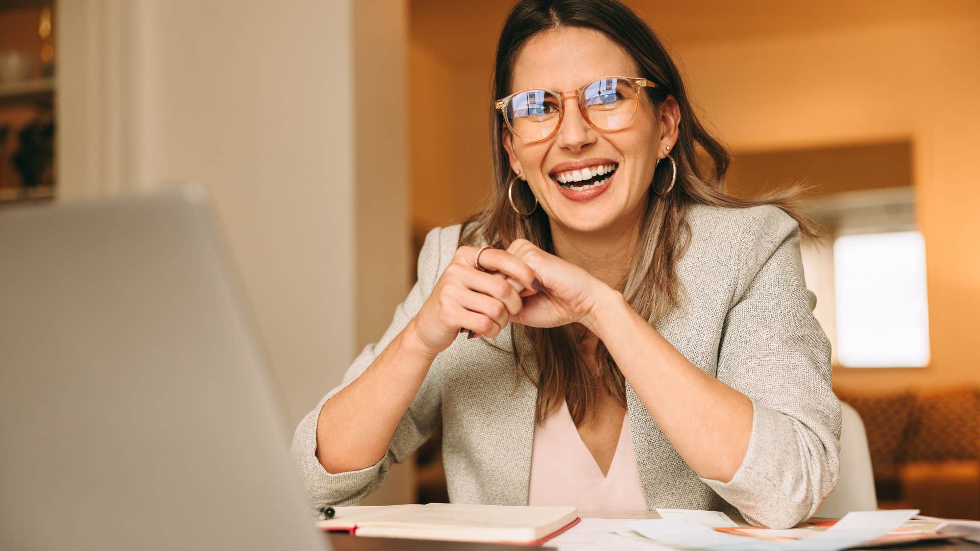 Woman with a controlled chaos desk working at home.