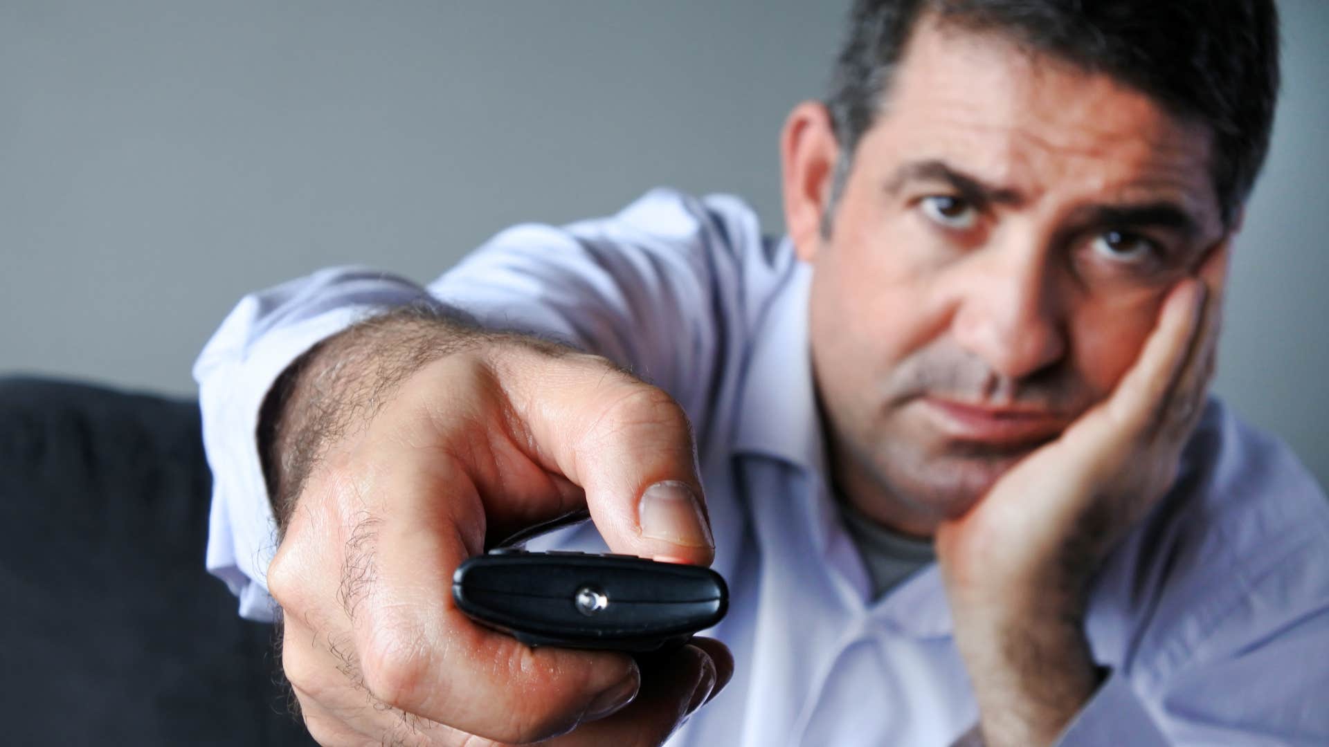 Man who chooses everything over intimacy watching TV.