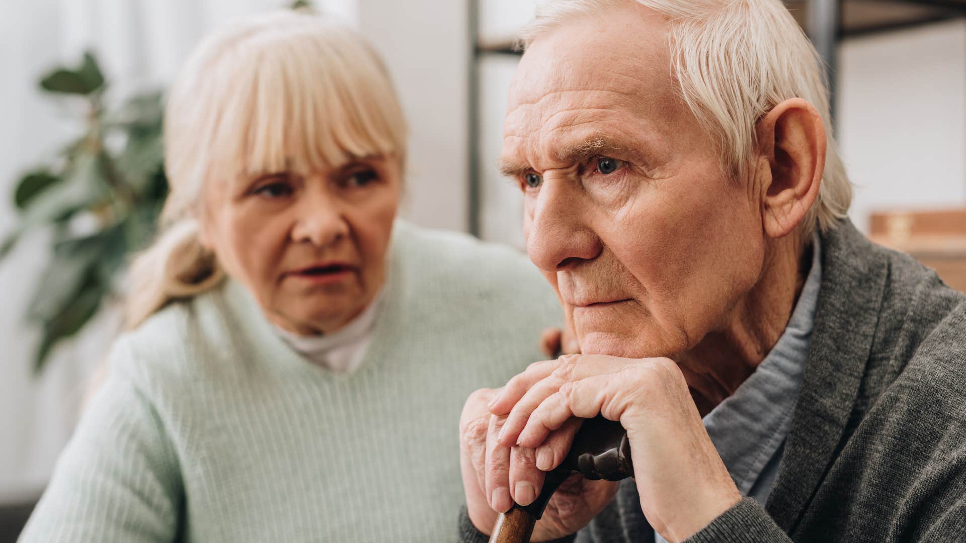Man pulling away from physical affection with his wife.