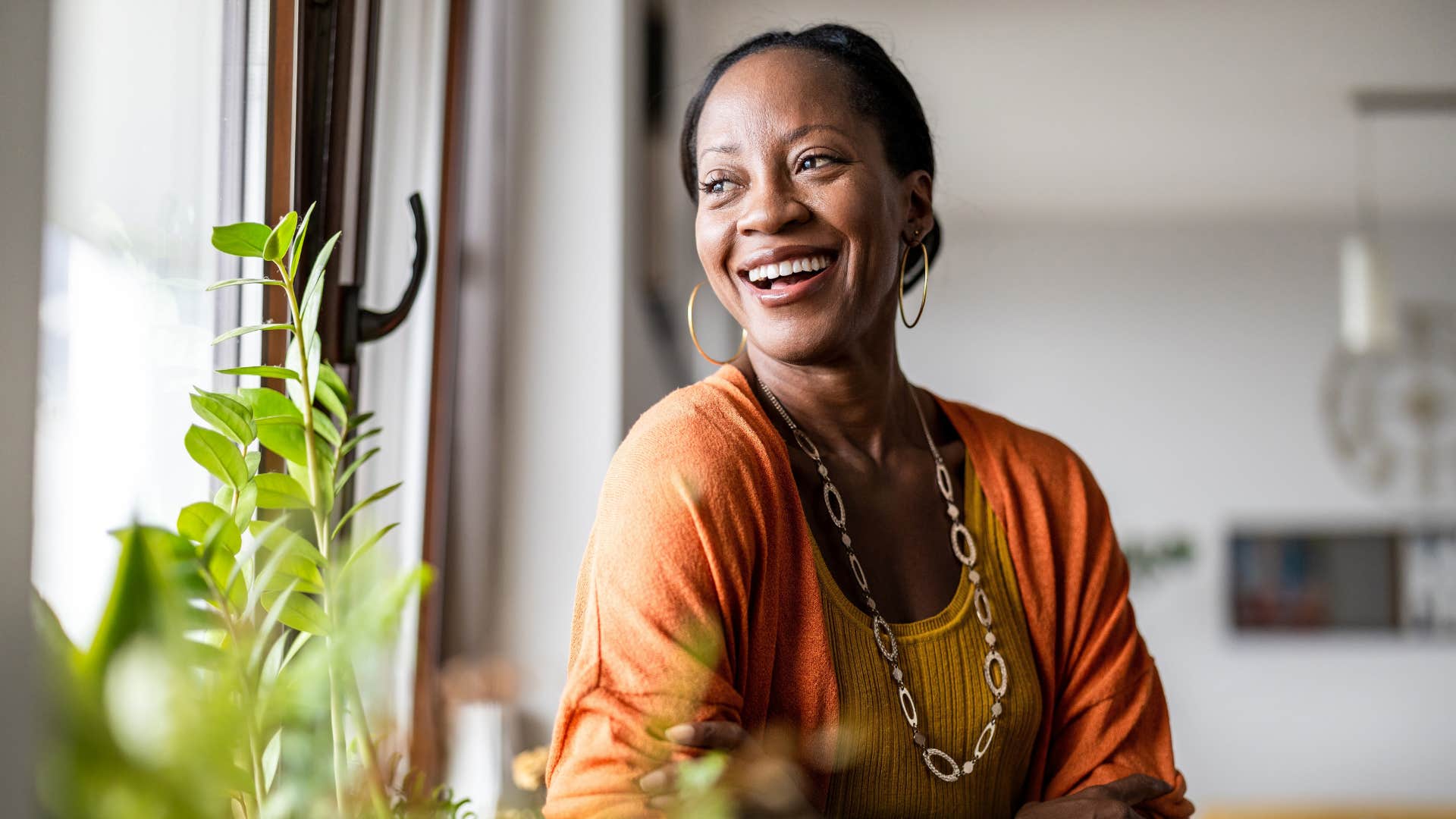 woman smiling at home focusing on herself