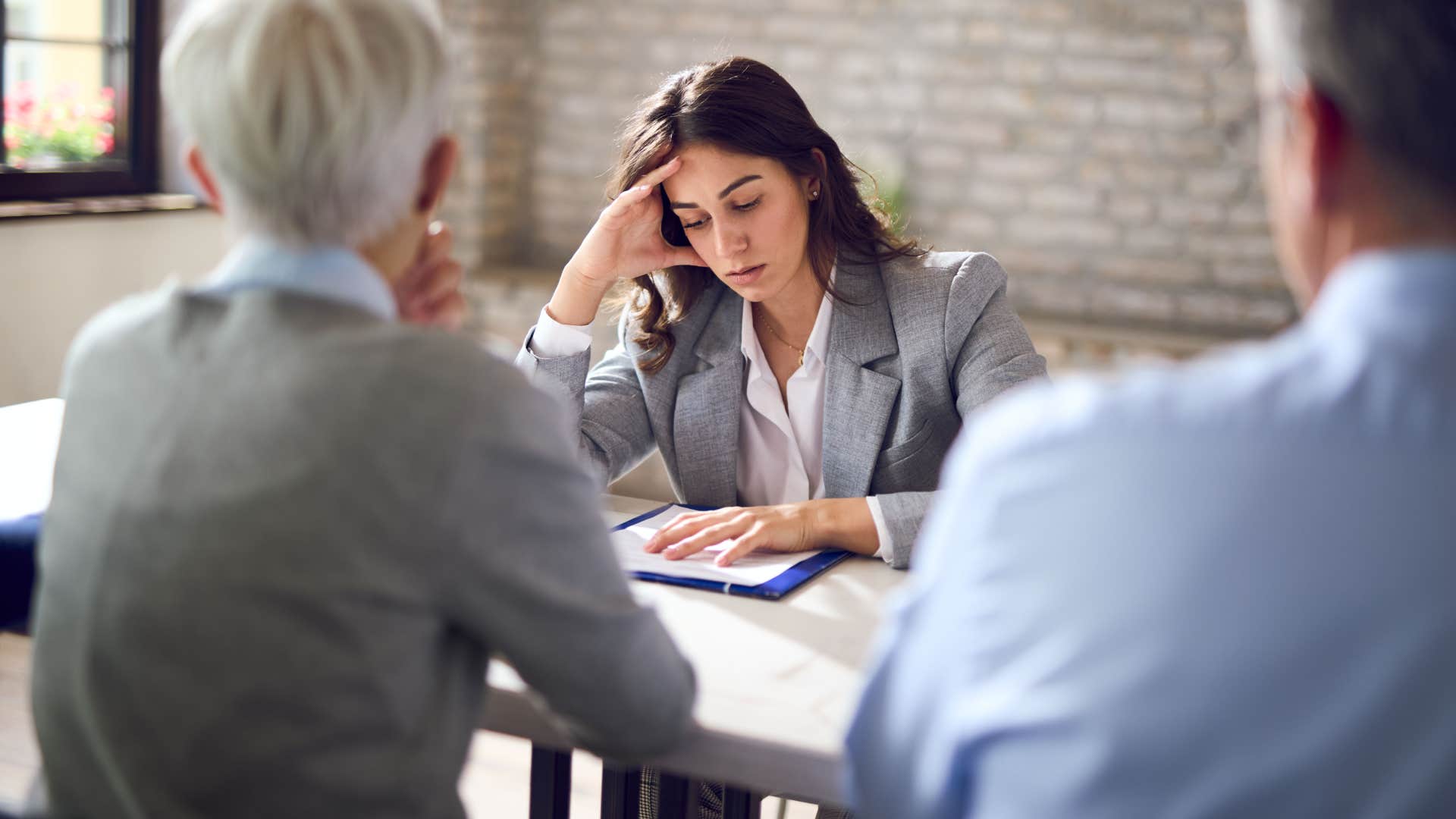 if a woman says I've done my part she secretly cant stand her coworkers Woman with head down with coworkers saying she's done her part