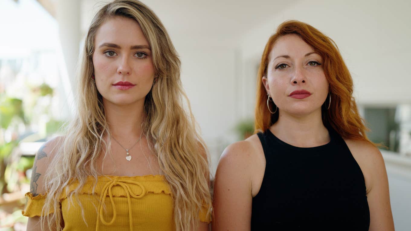 If A Woman Does These Things, She's Likely Scaring Off Really Good Friends two new friends unsure of each other standing side by side