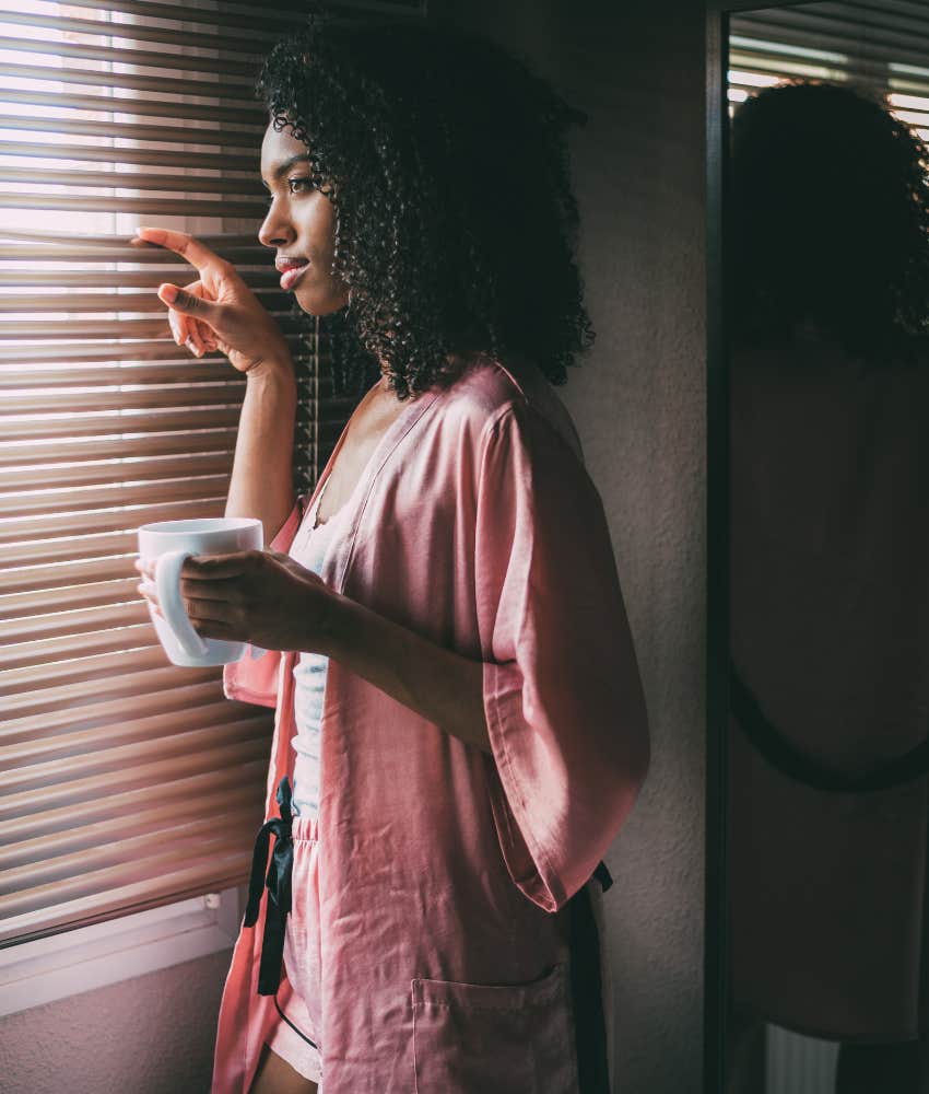 Neighbor looking at woman and complaining that she should close curtains