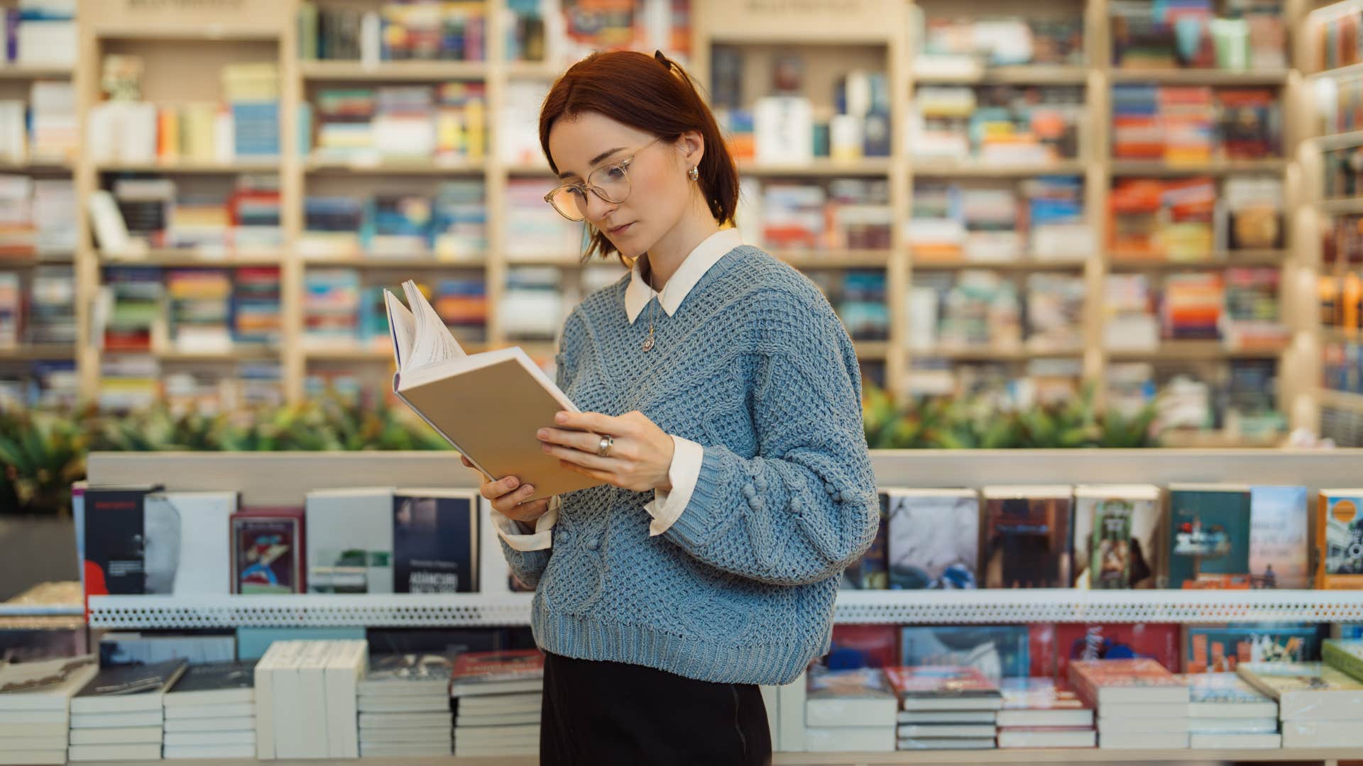 woman browsing the bookstore reading