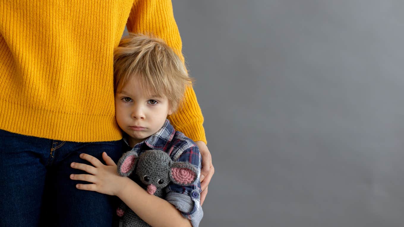 Woman Refuses To Pay For Sister’s $2,000 Gaming System Her Son Broke Because She Didn’t Baby-Proof The Room sad toddler hugging mom's leg