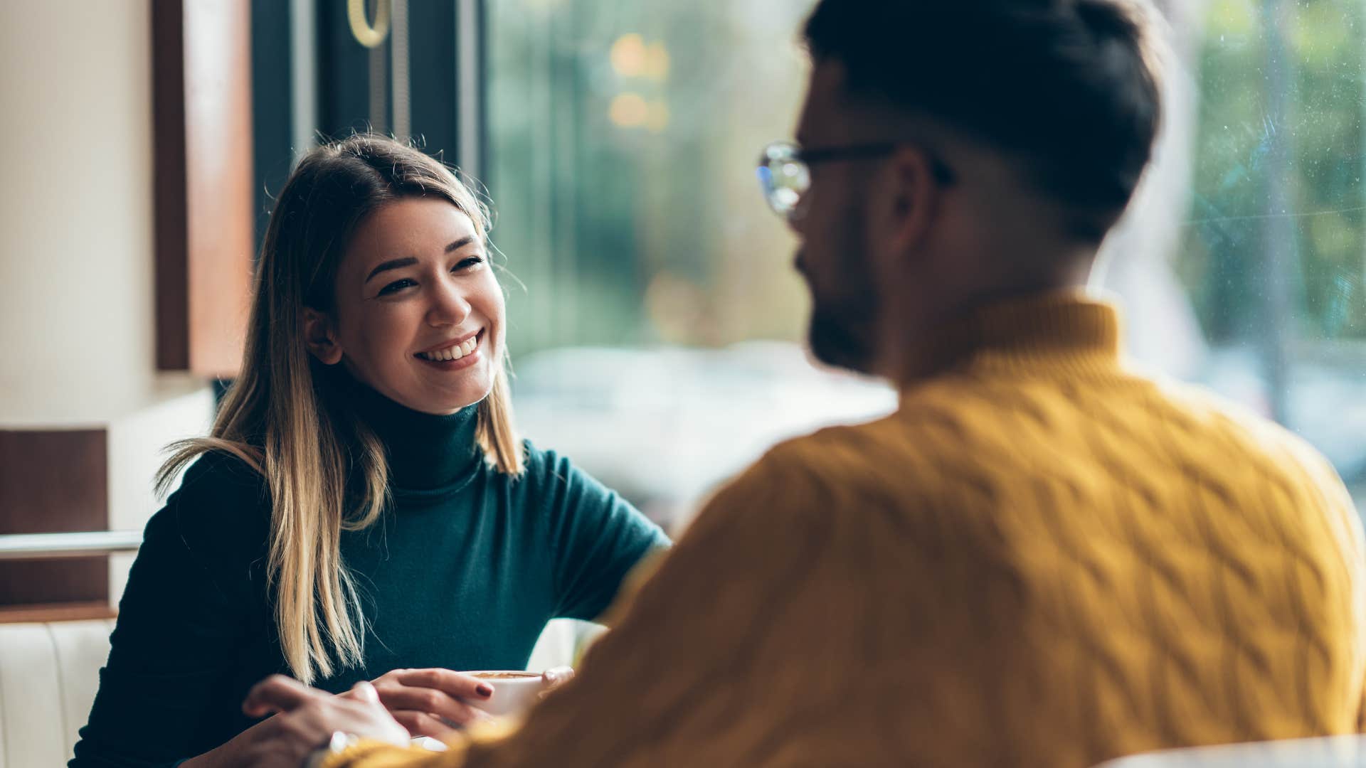 woman in green sweater asking why are you single as she's on a date