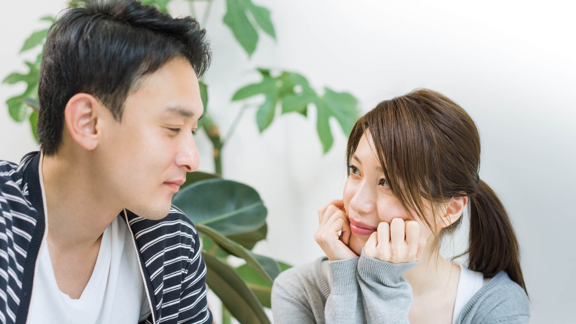 woman looking at man and thinking you're different as man looks down