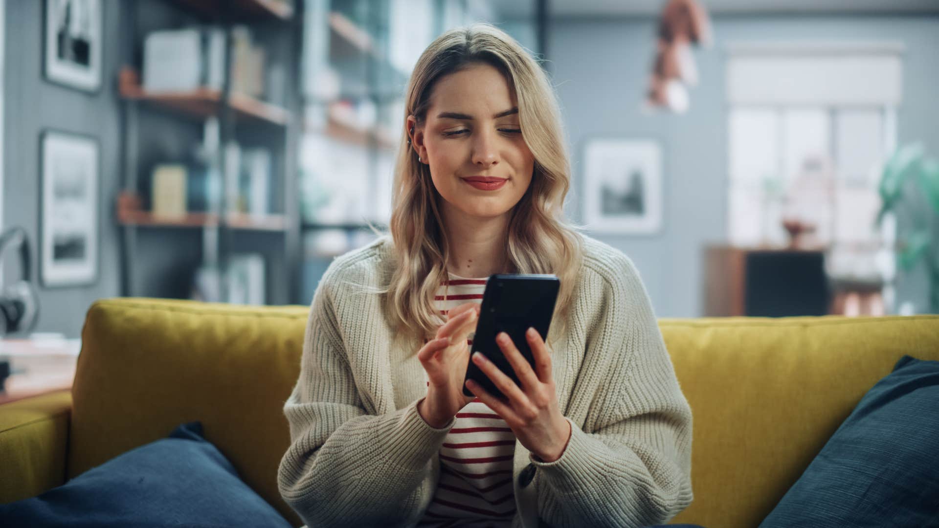 woman texting on phone and saying you always look good while smirking