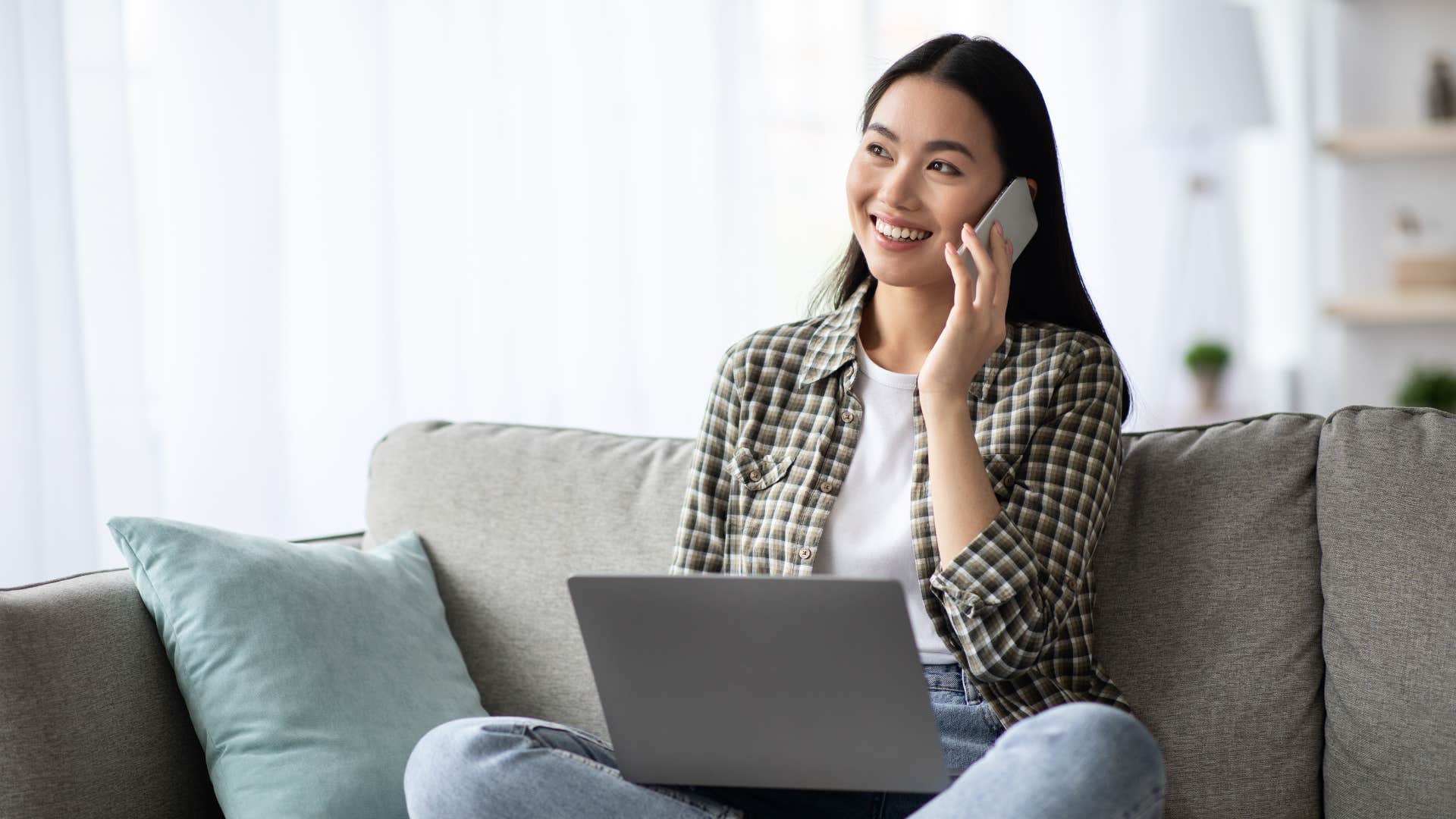 woman in white shirt on phone smiling as she always checks in with him