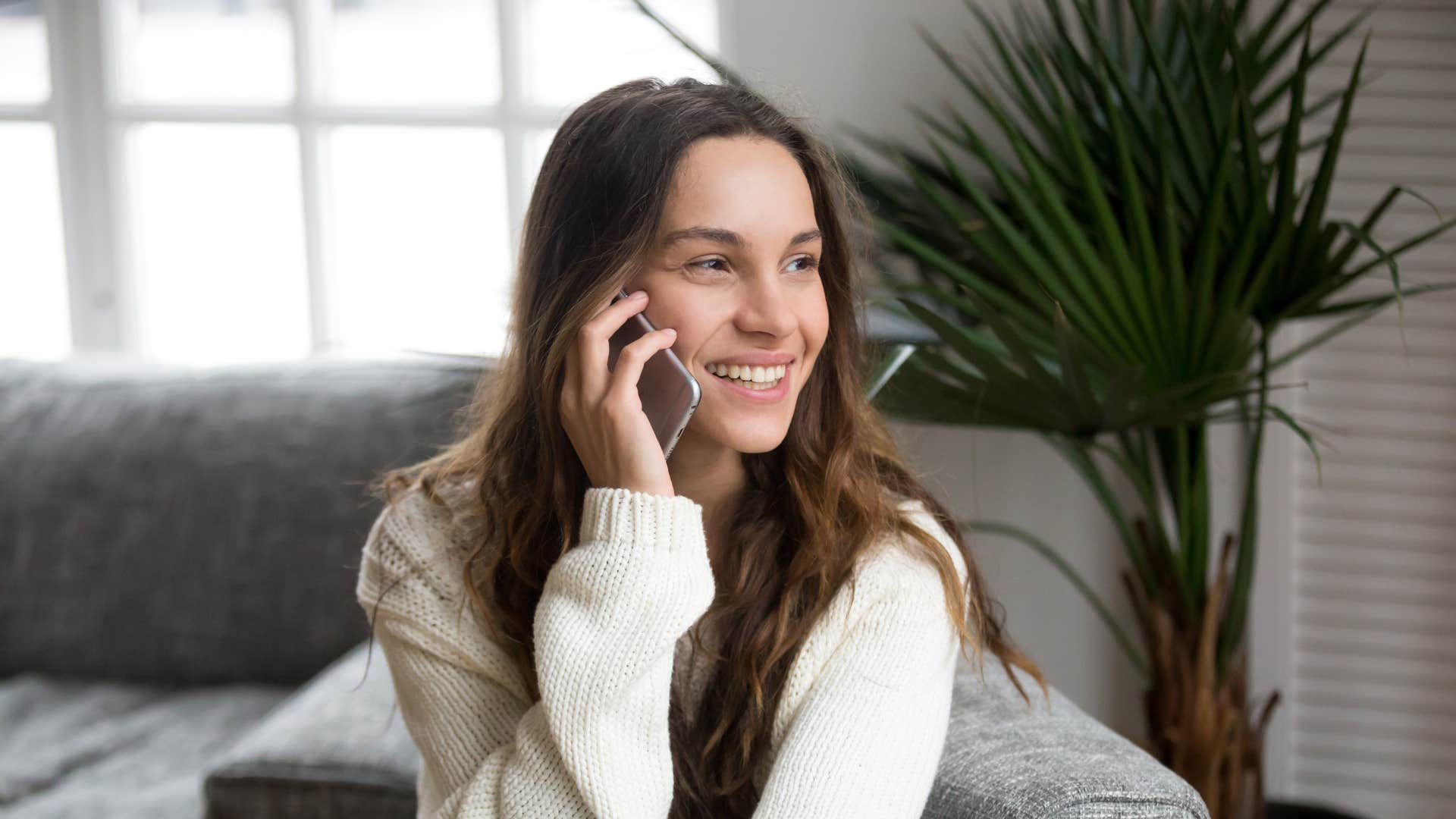 woman on phone asking to meet up more as she smiles
