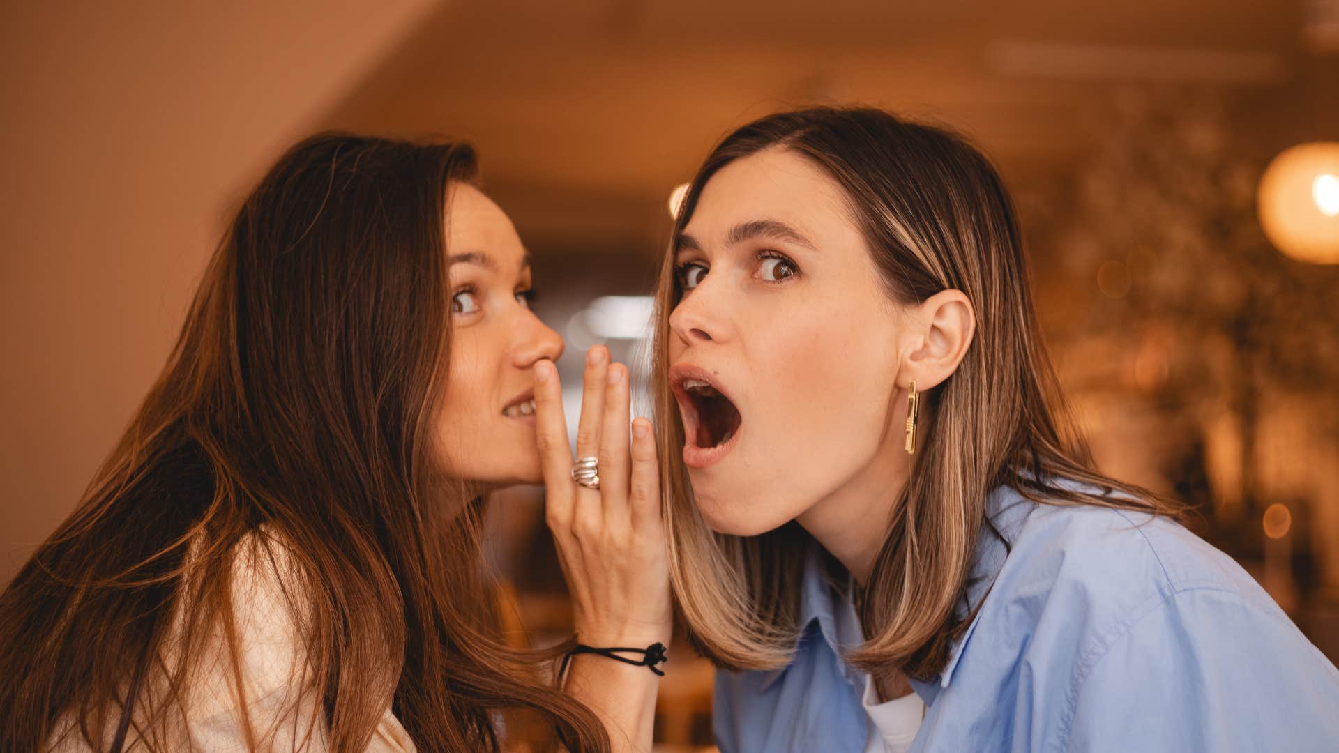 if a woman does these things, she's likely scaring off really good friends gossiping or talking behind other people's backs two friends gossiping talking behind other people's backs