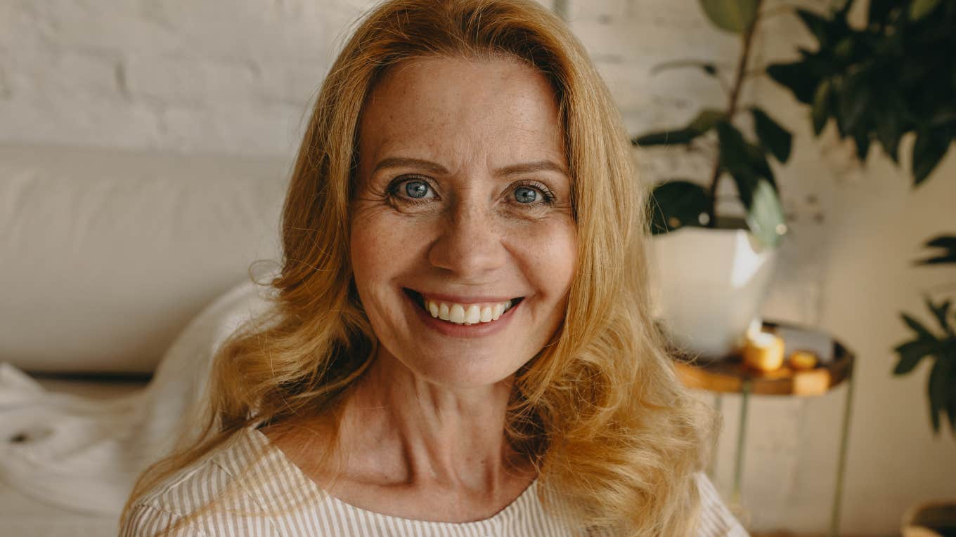 Women Who Are Happier Than Ever As They Get Older Probably Do These Things Differently happy older woman smiling at home