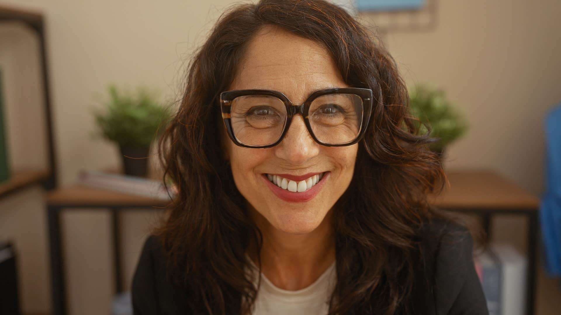Woman who feels authentically free smiling at home.