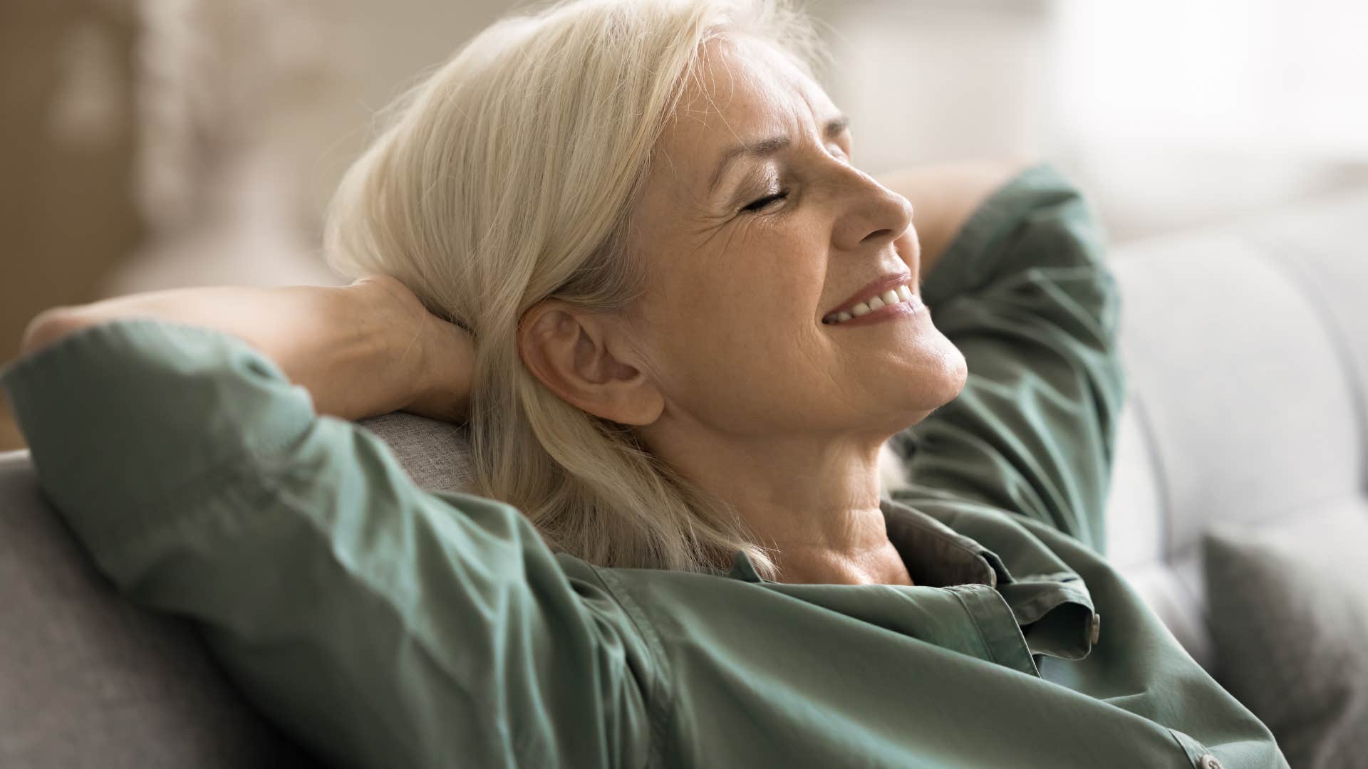 Woman who's formed a healthy relationship with her body smiling.
