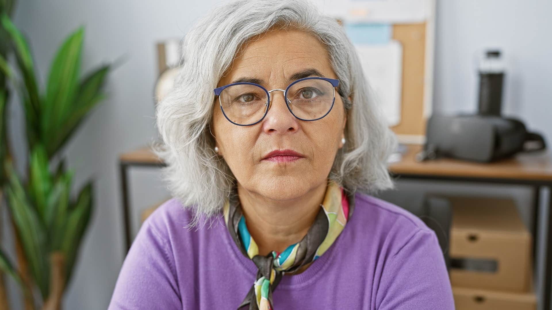 Woman who's let go of limiting beliefs looking at the camera.