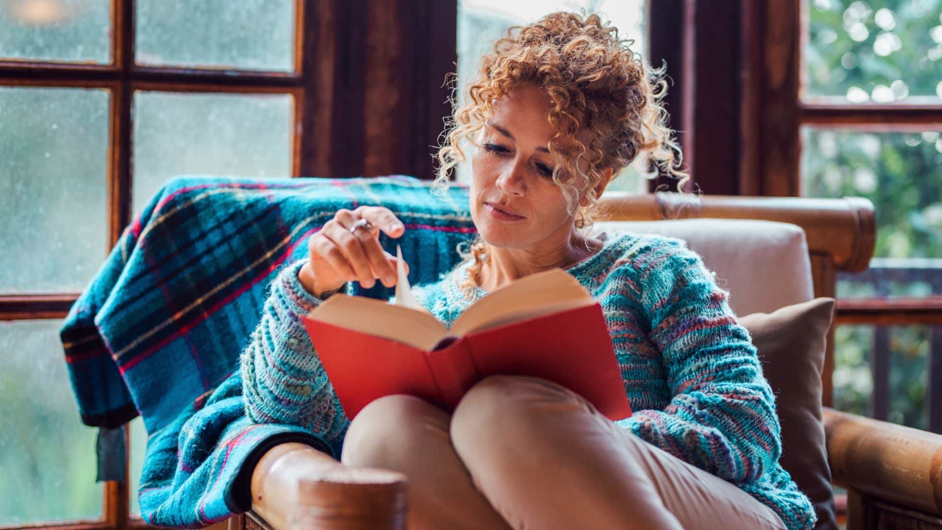 Woman who's started appreciating alone time reading at home.