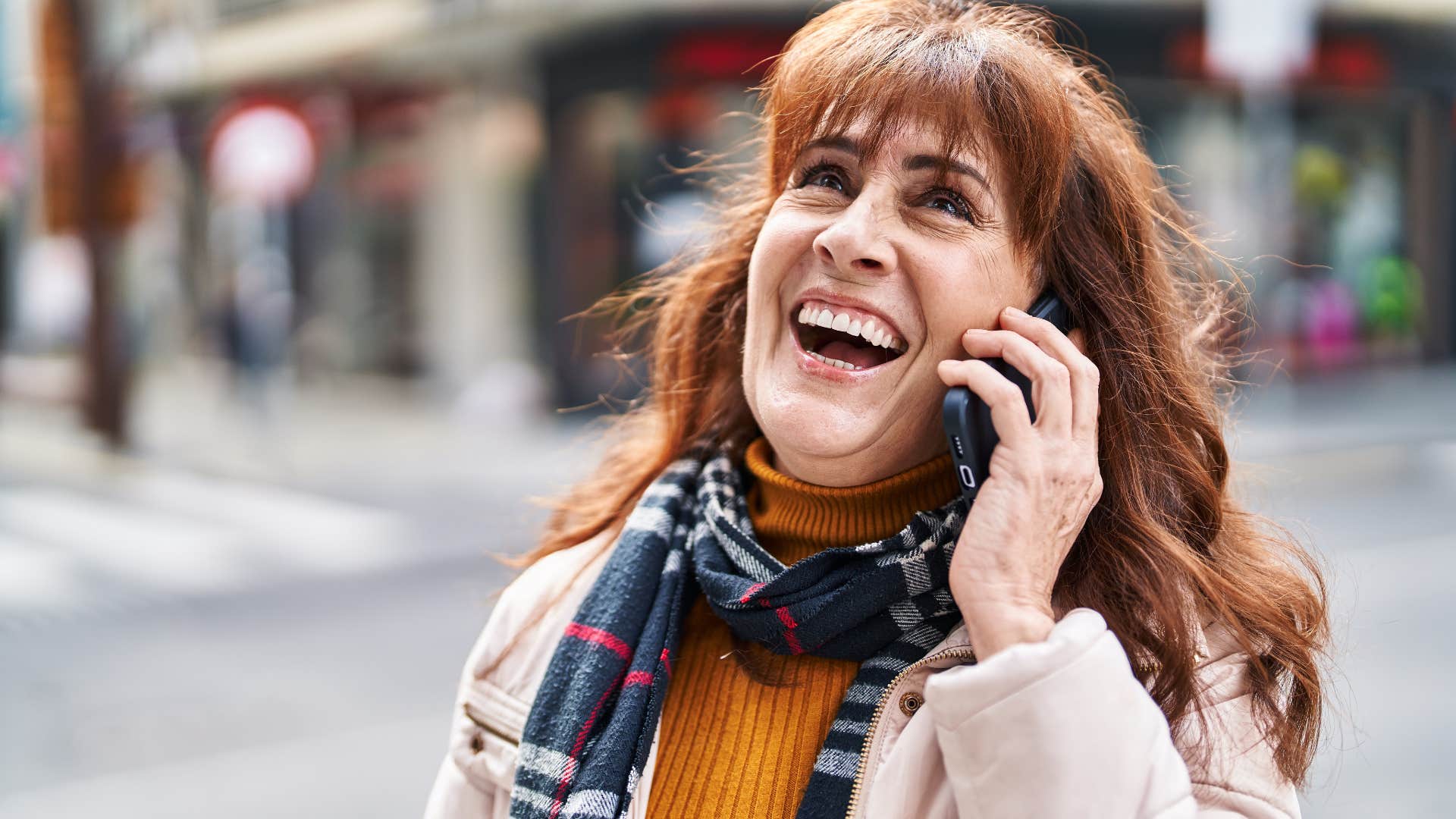 Woman who's stopped suppressing their own needs smiling at home.